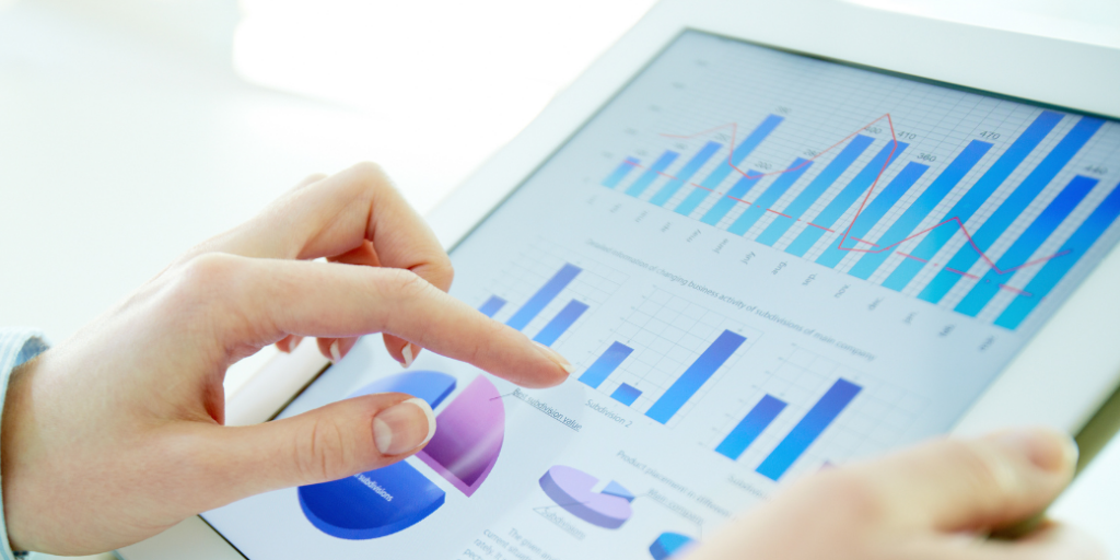 image of a person analyzing dashboard on tablet, illustrating data analytics in digital health tech